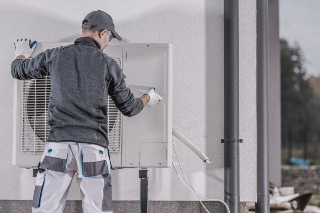 HVAC technician performing a service on a residential heat pump